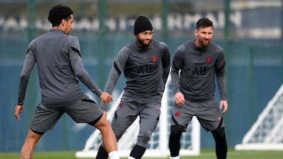 Paris Saint-Germain's Brazilian forward Neymar (C) controls the ball next to Paris Saint-Germain's Argentinian forward Lionel Messi (R) and Paris Saint-Germain's Brazilian defender Marquinhos during a training session at the club's Camp des Loges training ground in Saint-Germain-en-Laye, on the eve of their UEFA Champions Leage first round group A football match against RB Leipzig , on October 18, 2021. (Photo by FRANCK FIFE / AFP)