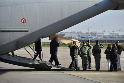 An Italian Air Force plane lands in Milan carrying the coffins of five Italian youths who died in the Swiss bar fire. Photo: EPA