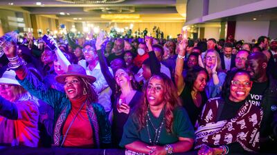 Warnock supporters cheer as another vote count in favour of their candidate is announced. EPA