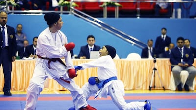 Hawra Mohammed Abbas, right, of UAE and Nafiseh Golshani of Iran in action during the West Asian Karate Championship held at Sharjah Ladies Club in Sharjah. Pawan Singh / The National