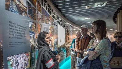 An Emirati volunteer informs visitors about the UAE. Giuseppe Aresu / The National