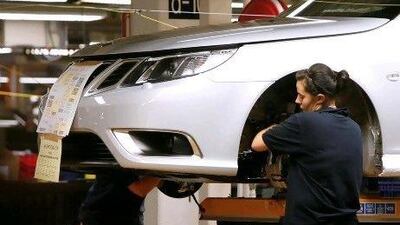 An employee works on a Saab car in a factory in Sweden. Bloomberg News