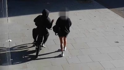 A mobile phone is snatched from a victim on a London street. Photo: Metropolitan Police