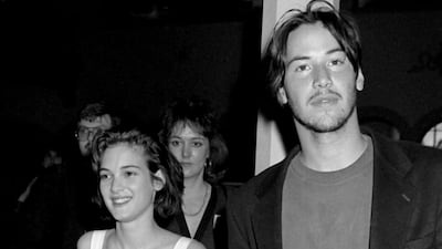 Winona Ryder, accompanied by Keanu Reeves, wears a fitted white top and matching skirt at the Fourth Annual Independent Spirit Awards on March 25, 1989, at the Hollywood Roosevelt Hotel in Hollywood, California. Getty