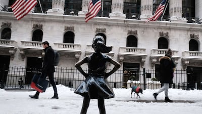 People walk by Fearless Girl statue in the New York snow in January. Getty Images / AFP