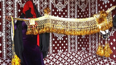 MADINAT ZAYED, UNITED ARAB EMIRATES - December 17, 2012 - Umm Khalid (35) from the Central Region of Saudi Arabia, is considered the queen of camel bling and has been making it for almost a decade producing pieces like the one she is holding that sell for 3,000 AED. With four people working for her Khalid has a caravan she sells her items from at the Al Dhafra Festival at Madinat Zayed, Al Gharbia, Abu Dhabi, December 17, 2012. (Photo by Jeff Topping/The National)