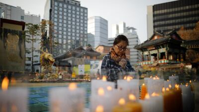 A mother prays at a Buddhist temple in Seoul, South Korea. Reuters