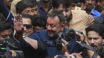 Bollywood actor Sanjay Dutt centre, waves to his fans as he arrives at his residence in Mumbai, India, Thursday, February 25, 2016. AP Photo