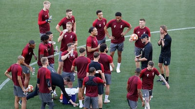 Jurgen Klopp talks to his Liverpool players as they train in Madrid. AP Photo,