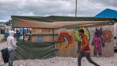 A shop at the Jungle mirant camp in Calais, France, spray-painted with spray-painted with the words "Please do not destroy the Jungle" , October 12, 2016. French authorities are preparing to raze the Calais "Jungle" camp and hav begun moving some unaccompanied children to Britain. Philippe Huguen / AFP