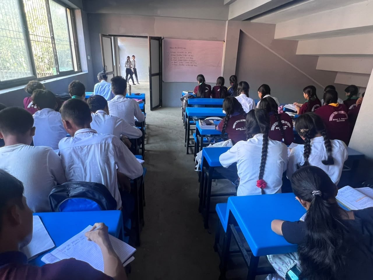School is held in morning and afternoon shifts and classes are conducted inside stairwells of a sports academy located on higher ground away from the river. Photo: Rajendra Dawadi