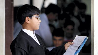 A pupil reads notes in a rebuilt government school in Ahingaro Dherai village
