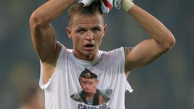 Lokomotiv Moscow's Dmitri Tarasov wears a shirt showing Russian president Vladimir Putin that reads 'Most polite president' after the Uefa Europa League round of 32 first leg football match between Fenerbahce and Lokomotiv Moscow at Sukru Saracoglu stadium, in Istanbul on February 16, 2016. Uefa, which prohibits political statements at its matches, charged the club and the player the next day. AFP
