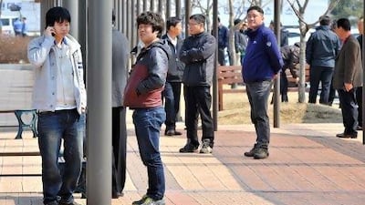 South Korean workers talk outside the inter-Korean transit office after being refused access to Kaesong joint industrial park in North Korea.