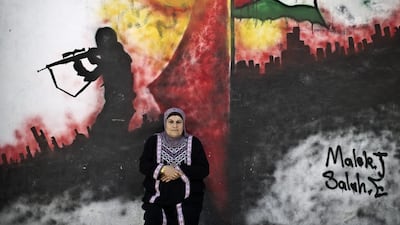 Palestinian refugee Layla Afaneh, 67, in front of a wall painted with a mural in the Kalandia refugee camp in Ramallah. Layla was a year and a half old when she and seven other members of her family were forced to leave their village of Barfeelia, near the central Israeli town of Ramla, when hundreds of thousands of Palestinians fled or were forced out their homes in the Mideast war over Israel’s 1948 creation.