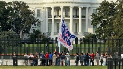 A supporter of Donald Trump waves a giant flag outside the White House in Washington on November 6. AFP
