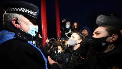 People paying tribute to murder victim Sarah Everard are involved in a confrontation with police, at Clapham Common, London. Crowds gathered despite the Reclaim These Streets vigil being officially cancelled. AP Photo