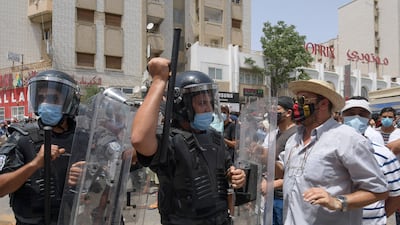 Members of the Tunisian security forces face off with anti-government demonstrators during a rally in front of the Parliament in the capital Tunis.