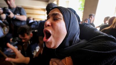 A woman mourns during the funeral in Beirut of Ghassan Najjar, a cameraman for Lebanese news channel Al Mayadeen, who was killed in an Israeli strike along with two other journalists in the southern Lebanese town of Hasbaya. Reuters