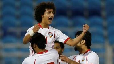 UAE's Omar Abdulrahman celebrates with his teammates after scoring against Qatar.