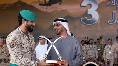Sheikh Mohamed is presented with a gift by Maj Gen Sheikh Nasser.