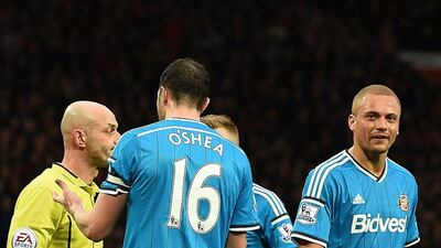 John O'Shea, centre, speaks to referee Roger East after he sent off Wes Brown by mistake during Sunderland's defeat to Manchester United on February 28. Paul Ellis / AFP