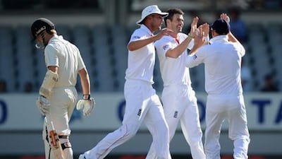 England's James Anderson celebrates with Stuart Broad and Jonathan Bairstow after taking Kane Williamson's wicket at Eden Park.