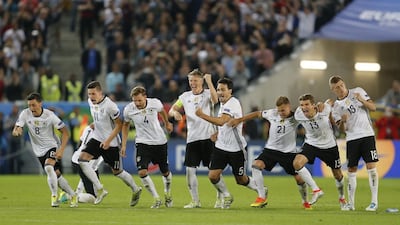 Germany players run to celebrate after winning the penalty shootout against Italy to book a place in the Euro 2016 semi-finals. Michael Probst / AP Photo