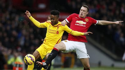 Liverpool's Raheem Sterling is challenged by Manchester United's Phil Jones on Sunday during their Premier League match. Phil Noble / Reuters