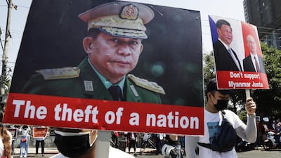 Protesters hold placards with pictures of military junta chief General Min Aung Hlaing, left, Chinese President Xi Jingping, second right, and Russian President Vladimir Putin during a protest against the military coup in Yangon. EPA