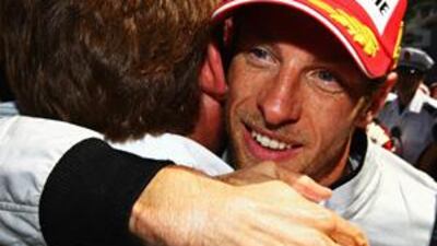 Jenson Button hugs one of his Brawn GP mechanics after triumphing in Sunday's Monaco Grand Prix. It was the Briton's fifth win of the season and he now leads the championship by 16 points.