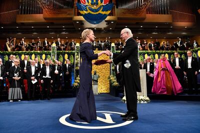 Chemistry laureate Frances H. Arnold, left, receives the prize from King Carl Gustaf of Sweden, during the Nobel Prize award ceremony, at the Stockholm Concert Hall, in Stockholm. AP