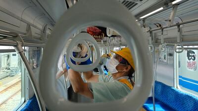Workers of Seibu Railway Company disinfect a railcar to prevent the spread of the COVID-19 coronavirus at the company's Kotesashi railcar base in Tokorozawa, Saitama Prefecture. AFP