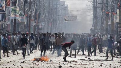 Ethnic Madhesi protesters throw stones and bricks at Nepalese policemen in Birgunj, a town on the border with India-Nepal border. Jiyalal Sah / AP Photo