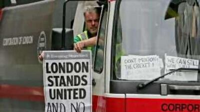 A London street cleaner displays a newspaper advertisement in reaction to the 2005 bombings.