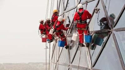 The Capital Gate tower has gondolas built into the design to clean its exterior. Antonie Robertson / The National