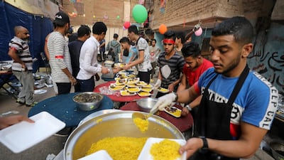 Residents of Ezbet Hamada in Cairo's Mataria district prepare for a mass iftar meal in Cairo, Egypt. Reuters