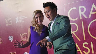 Director John M. Chu, right, and his wife Kristin Hodge arrive at the premiere of 'Crazy Rich Asians' at the Capitol Theatre in Singapore. Roslan Rahman / AFP