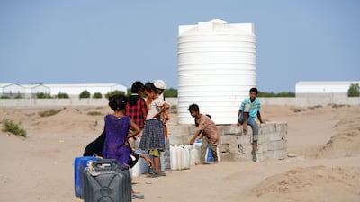 Children fetch water at a camp for internally displaced people in Aden, southern Yemen. EPA