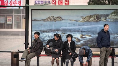 Commuters wait at a bus stop in Pyongyang. Buses are by far the most common means of public transport in the capital of around three million people, where access to private cars is rare, and offer the most extensive network. Ed Jones / AFP