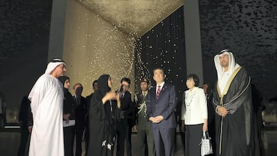 Mr Abe and his accompanying delegation visit the Founder's Memorial on Sunday while accompanied by Dr Al Jaber. Pawan Singh / The National