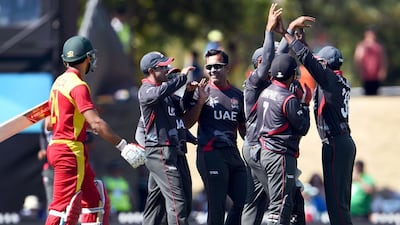 Mohammed Tauqir, centre, took two wickets against Zimbabwe with his off-spin at Nelson, New Zealand, on Thursday. William West / AFP