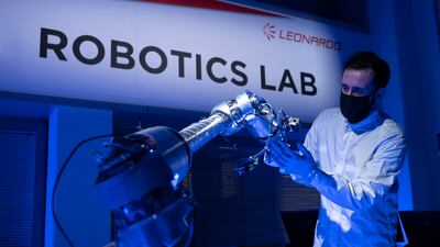 A prototype of the robotic arm is inspected by an expert at Leonardo. Photo: Leonardo