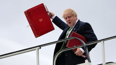 Britain's Prime Minister Boris Johnson boards a plane at London Stansted airport on Wednesday, before a visit to Finland and Sweden. AFP