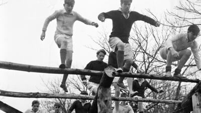 Pupils at Gordonstoun in 1956 doing physical training on an obstacle course. All three of Queen Elizabeth II's sons were educated there