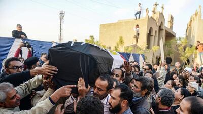 Pallbearers carrying a coffin as relatives of one of the victims of the Coptic Christian cathedral complex bomb attack mourn during the burial service in Cairo, Egypt on December 12, 2016. ISIL has claimed responsibility for the attack which killed 25 people. Mohamed Hossam/EPA