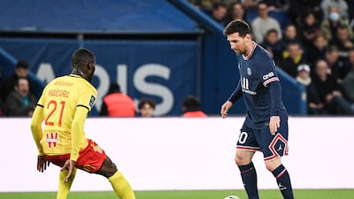Lionel Messi on the ball up against Lens defender Massadio Haidara. AFP