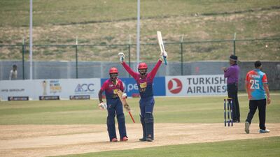 Rohan Mustafa raises his arms after reaching a century. He and Vriitya Aravind shared 275 for the fourth wicket against Kuwait.