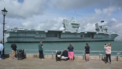 Admirers watch Royal Navy aircraft carrier HMS Prince of Wales sail towards Portsmouth Naval Base. The UK has announced three privately-funded ships to be used for Royal Navy tasks. PA