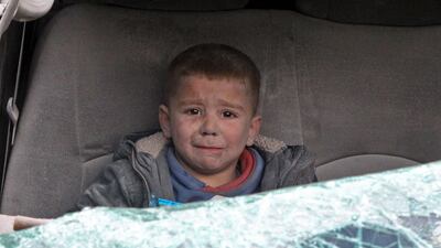 A boy cries as he is evacuated after a regime air strike on Ariha town in Syria's last major opposition bastion of Idlib. All photos from January 15. AFP